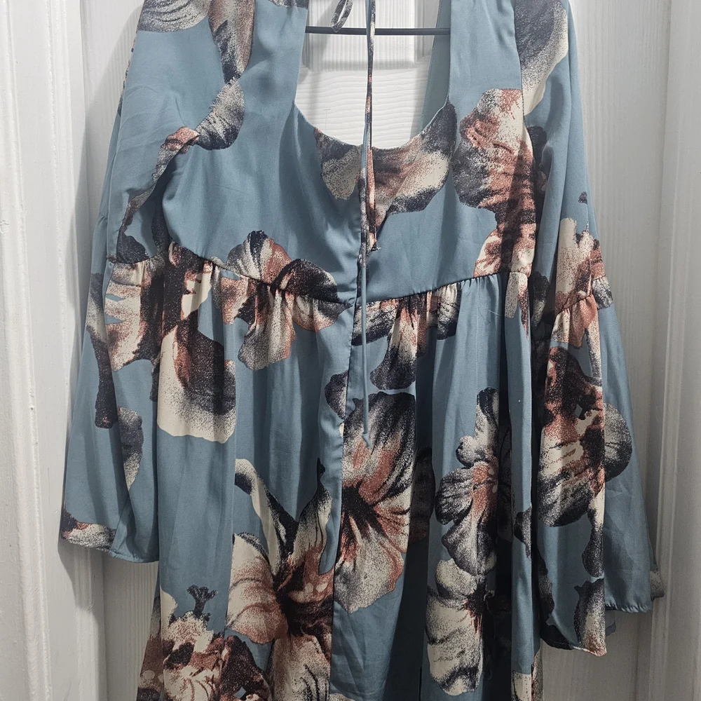 ￼

This is an Altar'd State Blue Floral Square Neck Tie Back Mini Dress - Picture 4 of 5